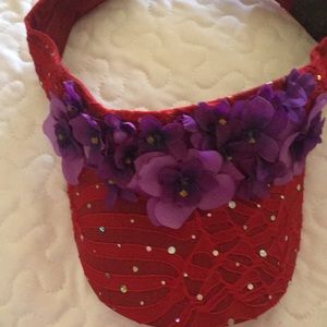 Red visor trimmed in purple flowers